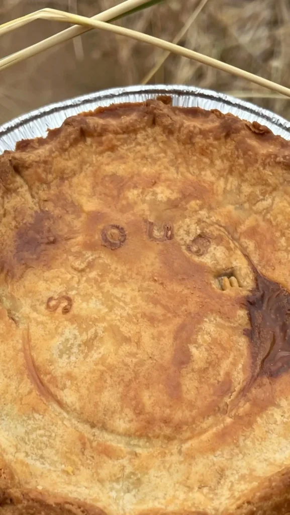 Close-up of a homebaked Scouse pie with “Scouse” written on top in Liverpool