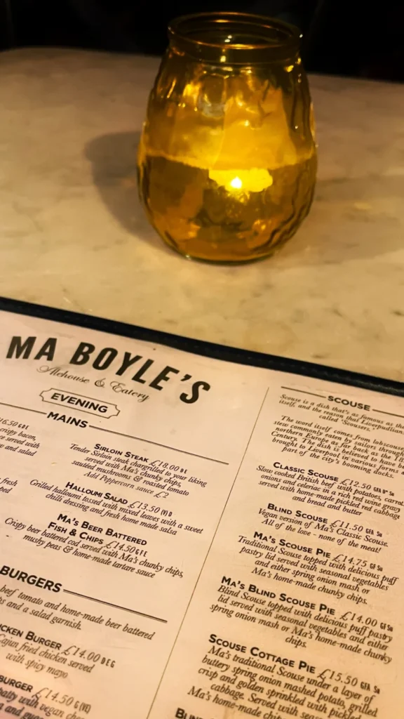 Menu of Ma Boyle’s Alehouse & Eatery on a marble table with a candle in Liverpool