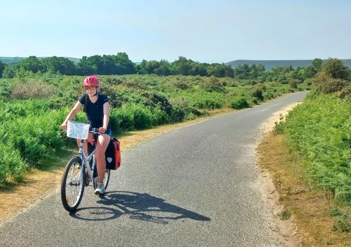 Ever Prel cycling through green English countryside on a sunny summer day