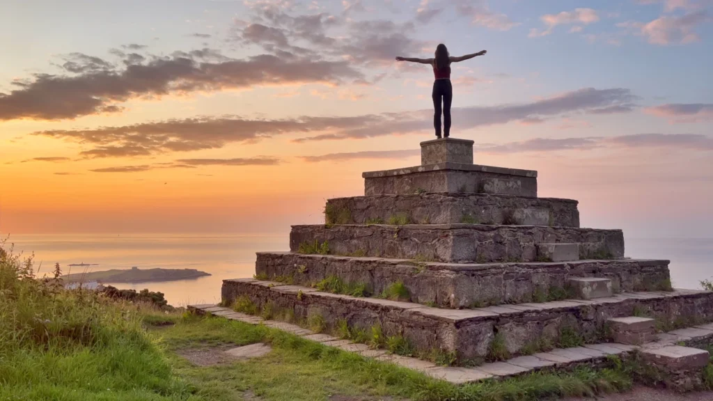 Sunrise view from the Pyramid of Dublin on Killiney Hill, with solo traveller Ever Prel standing at the top