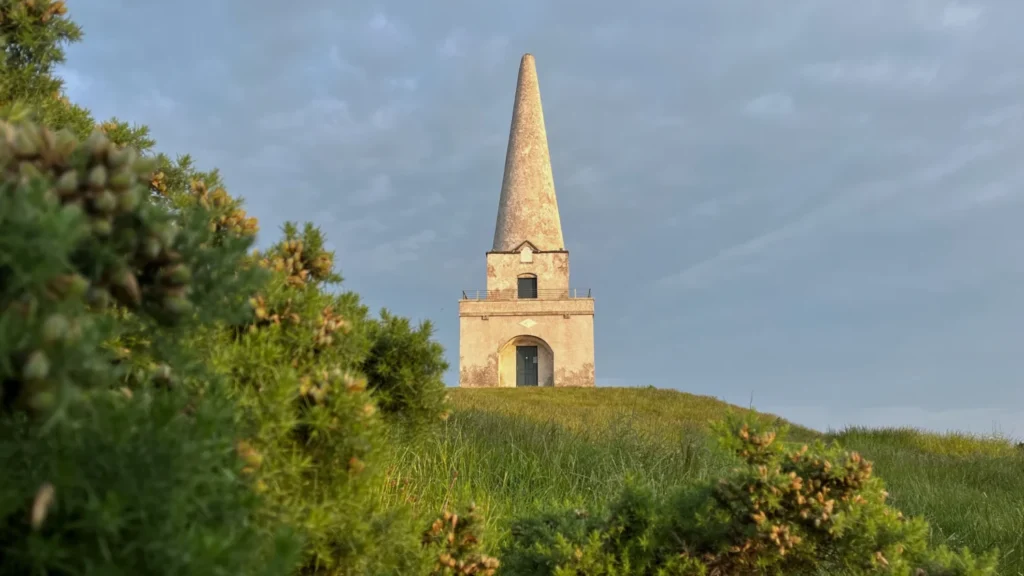 The Obelisk on Killiney Hill on a clear sunny day with blue skies
