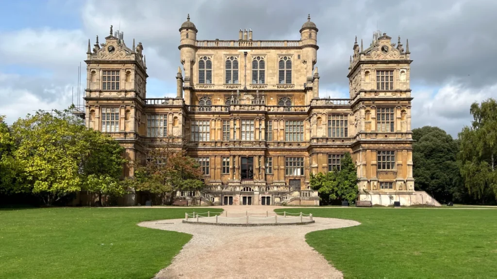 Wollaton Hall facade with trees and park, sunny day, Nottingham