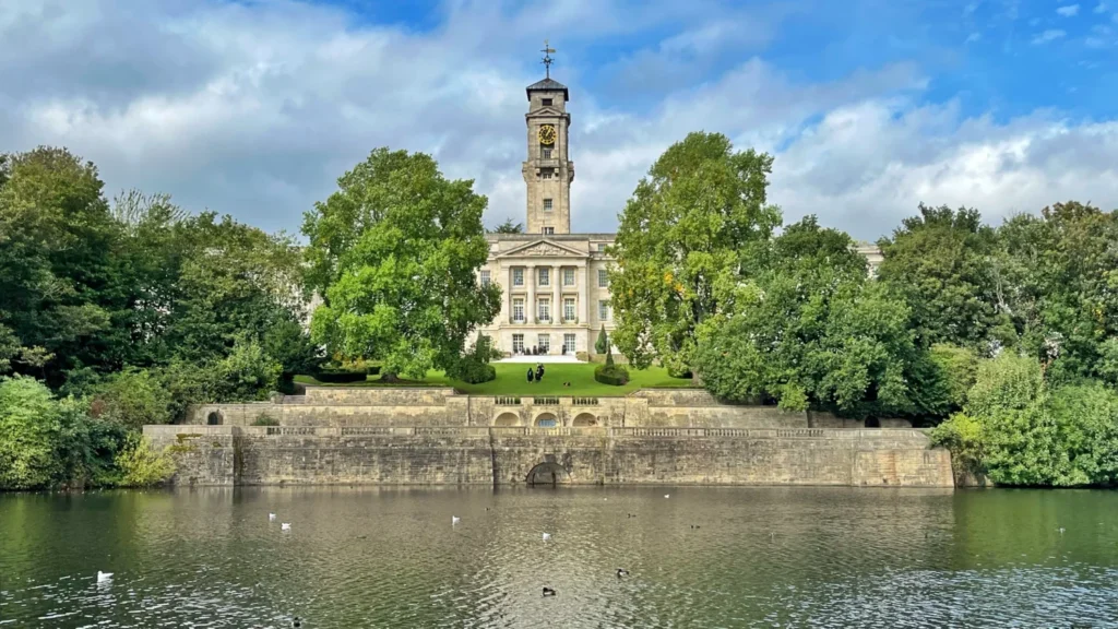 Highfields Park Nottingham England with boating lake and University of Nottingham building in the background