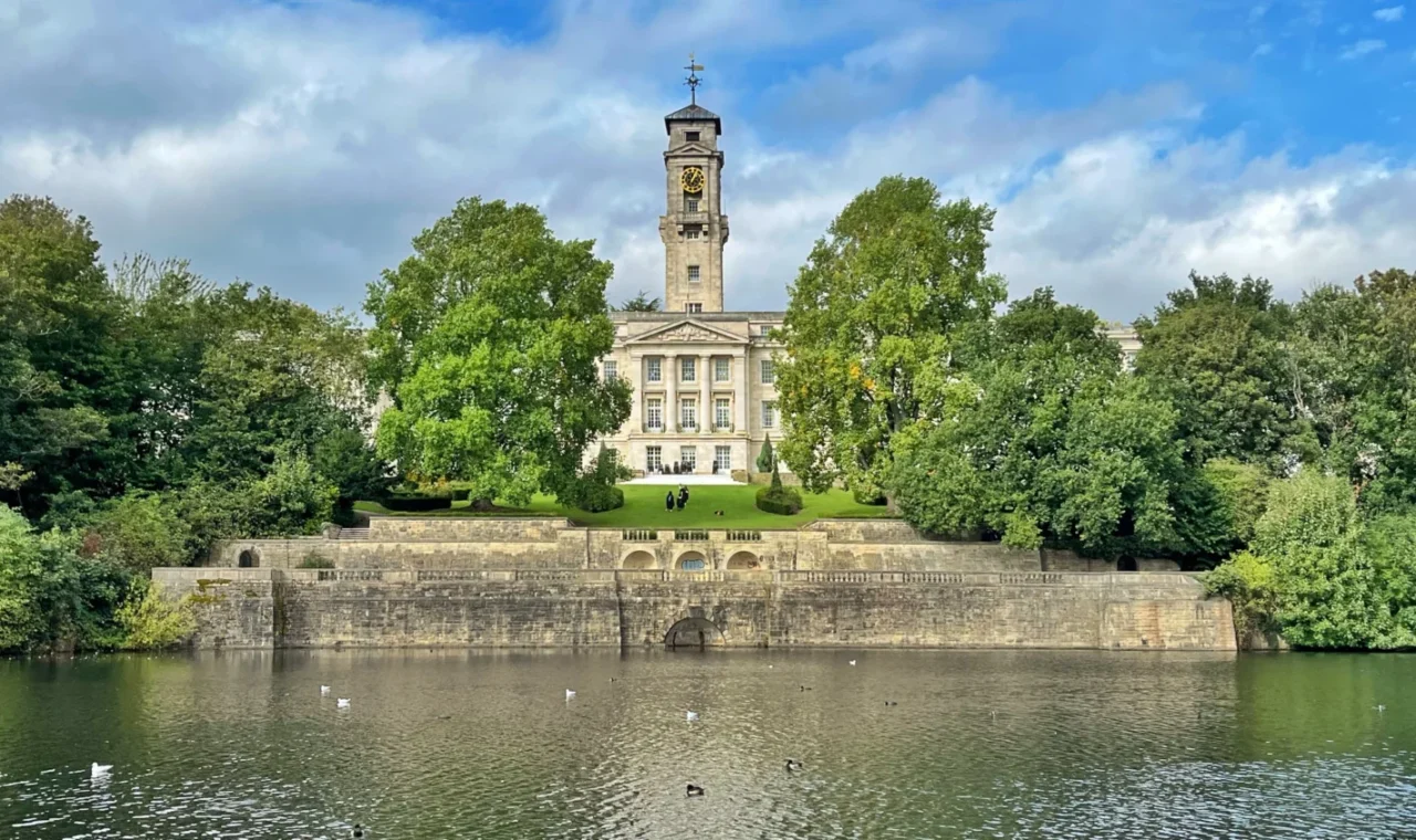 Highfields Park Nottingham England with boating lake and University of Nottingham Trent building in the background