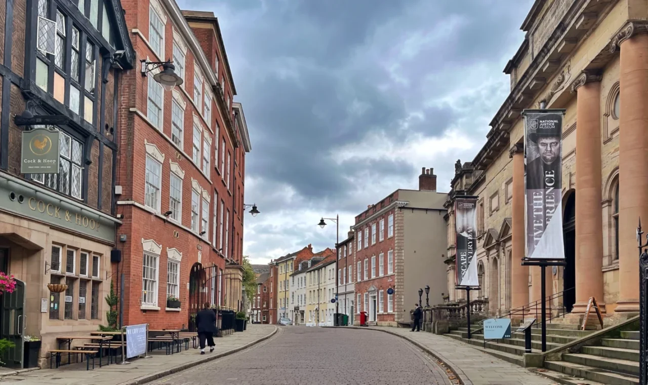 Historic street scene during a weekend in Nottingham with traditional brick buildings and the National Justice Museum on a cloudy day
