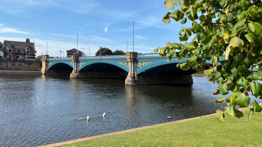 Trent Bridge crossing the River Trent in Nottingham on a sunny day with greenery in the foreground