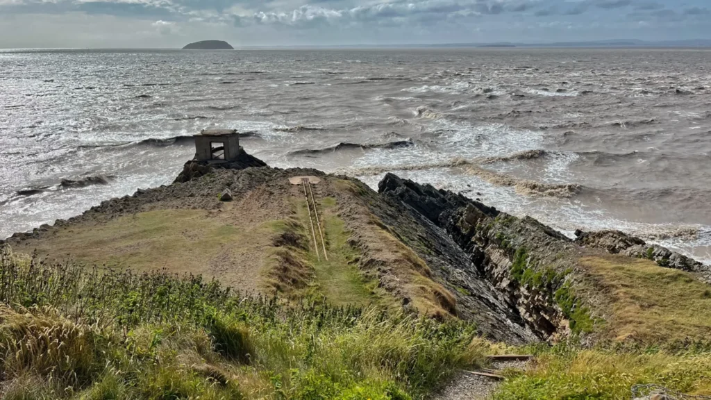 Fort ruins and old rail track at the tip of Brean Down with Steep Holm island in the distance