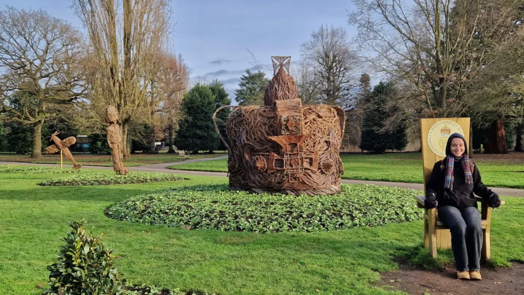 Coronation-themed display in Grosvenor Park, Chester, England, featuring a giant crown, King Charles III throne, winter gardens and festive Christmas atmosphere.