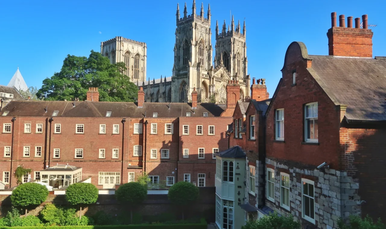 York Minster towers rising above red brick rooftops in York, England