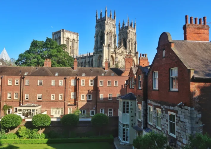 York Minster towers rising above red brick rooftops in York, England