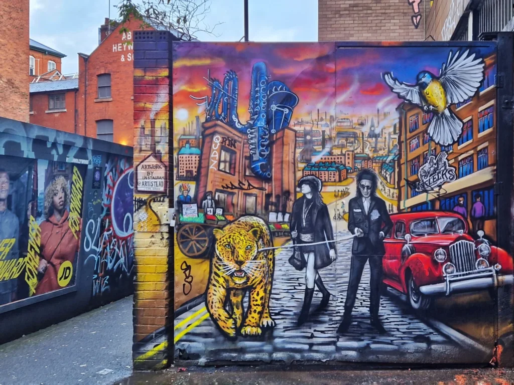 Evan Barlow mural "Evidently Chickentown" on Red Lion Street, Manchester, featuring a leopard, vintage car and punk-styled figures