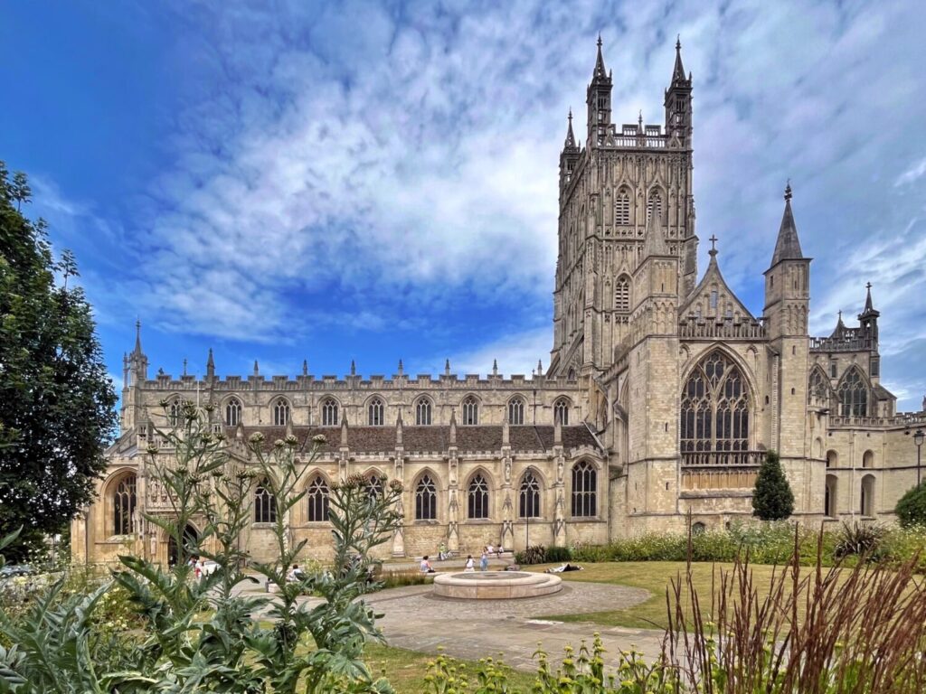 Gloucester Cathedral from College Green, the south side and central tower above summer planting