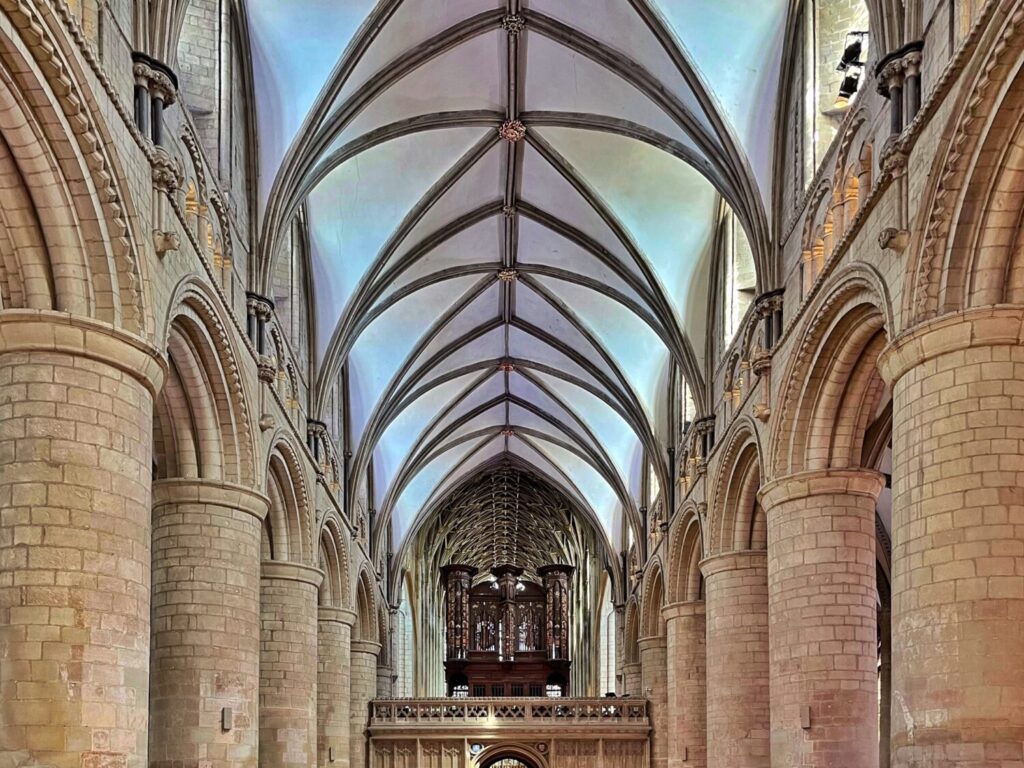 The Norman nave at Gloucester Cathedral, looking east down the round pillars to the organ case