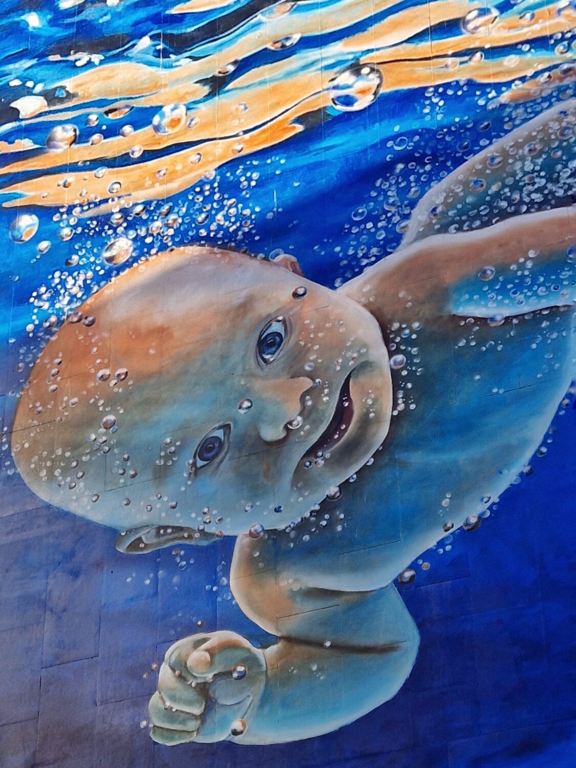 Underwater baby mural in blue tones on Harrington Street, Liverpool