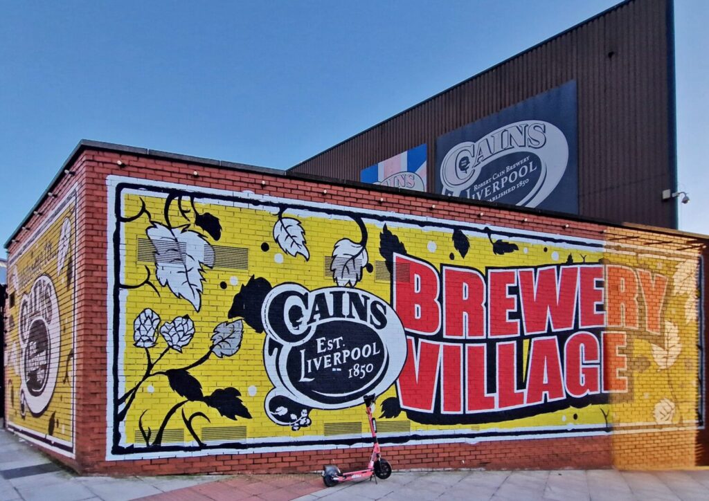 Cains Brewery Village mural with hop leaves and vintage branding, Baltic Triangle Liverpool