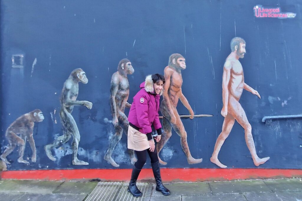 Evolution of Man street art mural in Liverpool's Baltic Triangle showing the march of human progress