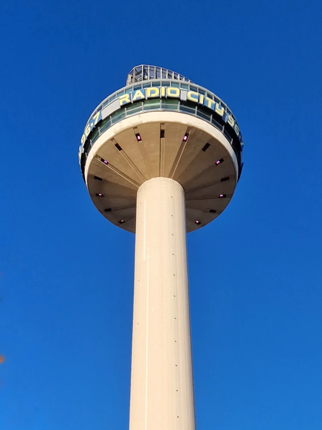 Low-angle view of St John's Beacon, the Radio City Tower, against a clear blue sky in Liverpool