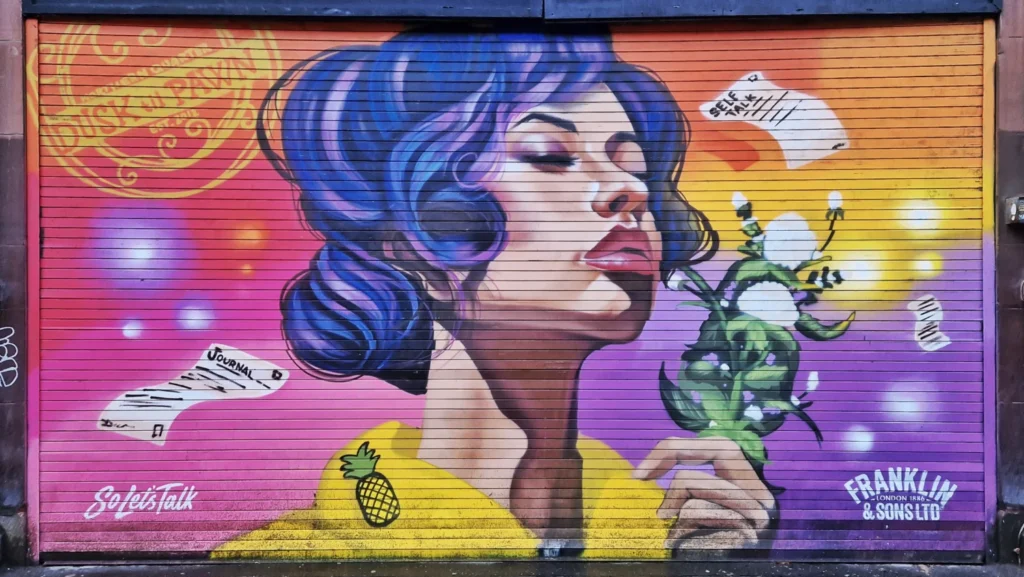 Shawn Sharpe "So Let's Talk" mural on a roller shutter at Dusk til Pawn, Stevenson Square, Manchester