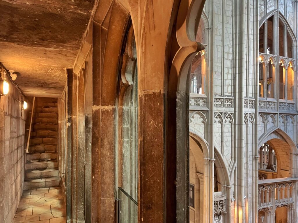 Worn stone stairs up to the Tribune Gallery, with the quire's Perpendicular stonework beyond
